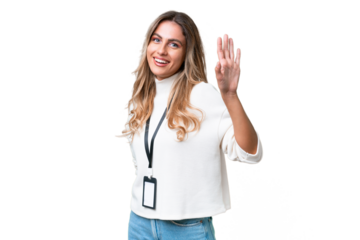 Young Uruguayan woman with ID card over isolated background saluting with hand with happy expression