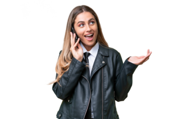 Business pretty Uruguayan woman wearing a biker jacket over isolated background keeping a conversation with the mobile phone with someone
