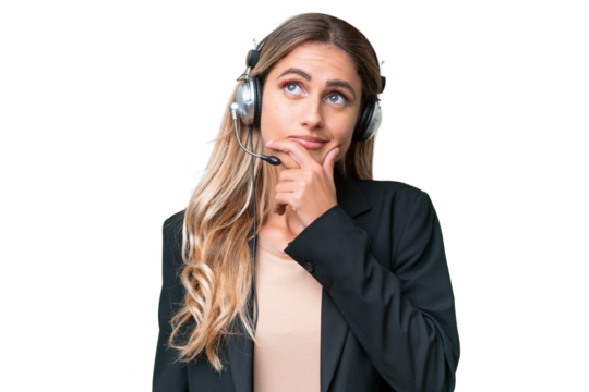 Telemarketer pretty Uruguayan woman working with a headset over isolated background having doubts and with confuse face expression