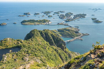 Ocean and Henningsvaer city view with rocky islands and mountain slopes, Lofoten Norway