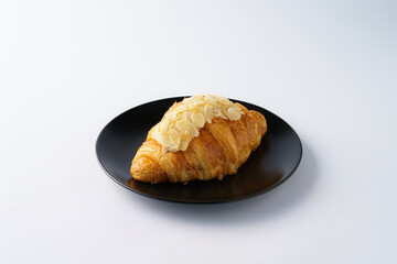 Delicious Almond Croissant on Black Plate