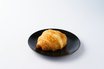 Freshly Baked Croissant on a Black Plate