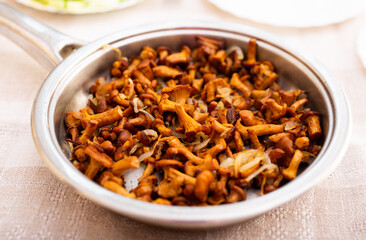 Delicious fried chanterelles in a frying pan