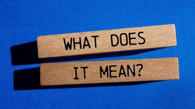 What does it mean question writing on wooden blocks on blue background. Conceptual what does it mean question symbol.