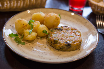 Chicken cutlet with vegetables with boiled potatoes on a plate