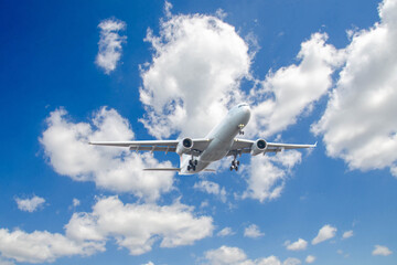 White passenger airplane flying in the sky amazing clouds in the background - Travel by air transport. High quality photo