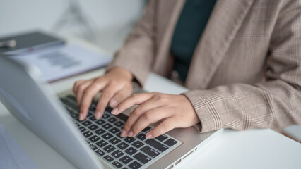 business woman working with laptop Hands typing  keyboard. Professional investor working new start up project. business planning in office. Technology business.