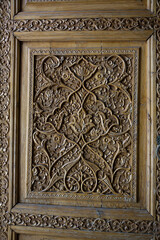 Detail of a carved wooden door entrance to a madrassa at the Registan in Samarkand