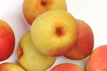 Green yellow red ripe mini pear sweet juicy on white background basket fork