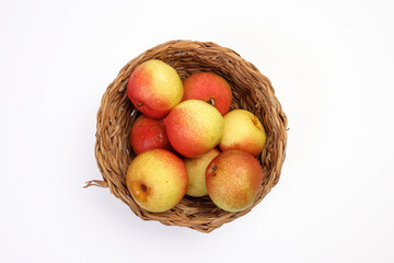 Green yellow red ripe mini pear sweet juicy on white background basket fork