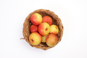 Green yellow red ripe mini pear sweet juicy on white background basket fork