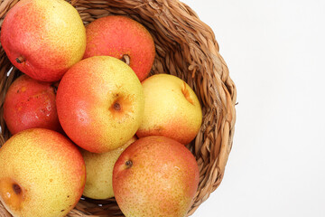 Green yellow red ripe mini pear sweet juicy on white background basket fork