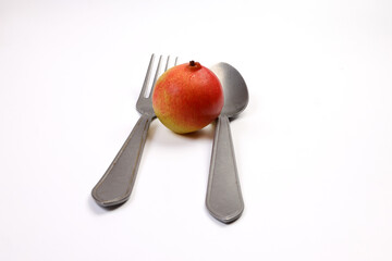 Green yellow red ripe mini pear sweet juicy on white background basket fork