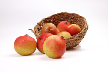 Green yellow red ripe mini pear sweet juicy on white background basket fork
