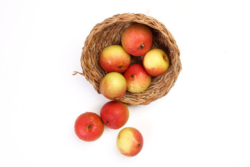 Green yellow red ripe mini pear sweet juicy on white background basket fork