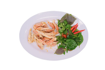 a plate of salted sentinel crab claws accompanied by fresh herbs and red chilies on a white background. The dish looks appetizing and well-presented, highlighting its gourmet appeal.