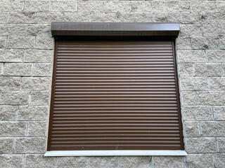 Window closed shutters on the wall of a house