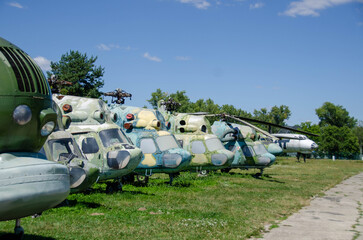 Samples of old military equipment. The engine and propeller of the cargo plane against blue cloudy sky. Separate parts of the fuselage, close-up. Old airplane in museum of aviation at Retro cars