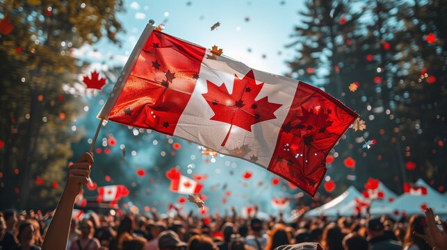 A Canadian flag held by a crowd of people celebrating Canada Day. The scene is filled with joyful faces and festive decorations