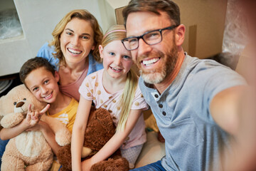 Happy family, portrait and moving in with box for selfie, new home or renovation together. Mother, father and children with smile or boxes for picture, memory or photography in property or house