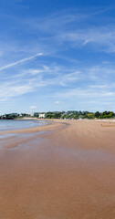 Torquay image of Torre Abbey sands. Vertical panorama from beach sand to blue sky. 