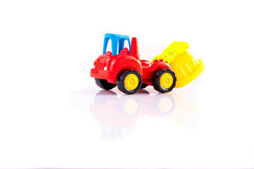 Dump truck toy isolated on white background with reflection. Construction industrial equipment for transporting materials