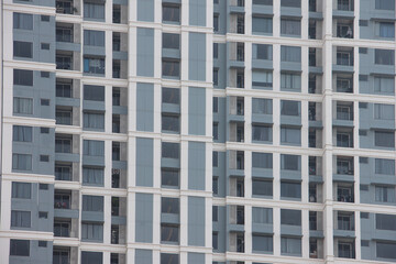 Fototapeta premium Big tall building background with windows and glass.