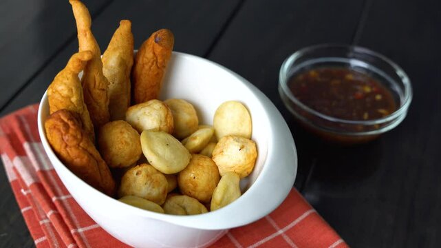 a bowl of kikiam, fish ball and squid ball with sweet chili soy sauce