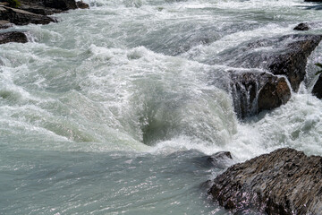 Close up of a waterfall along a rocky river