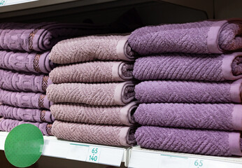 Multi colors Stack of bath towels. towels in a stack on the shelves in the supermarket. family shopping.