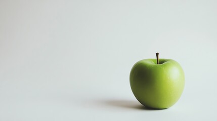 A green apple on a white background.