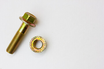 A pair of golden-colored screw and bolt on a white background.