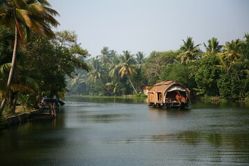 Traditional Indian houseboat sailing on a river in Kerala, India
