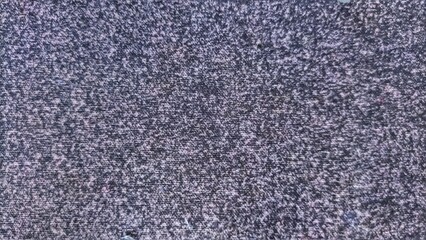 Abstract texture of a mousepad surface with a gradient of purple and gray speckles