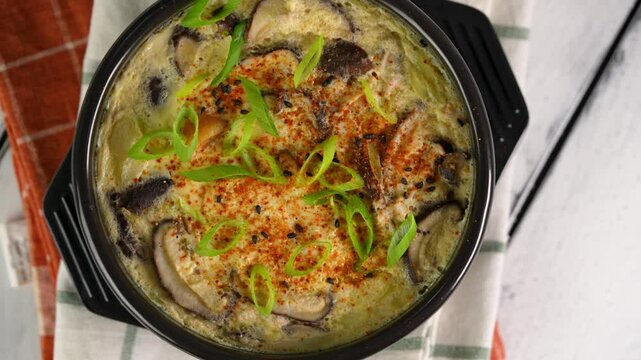 steamed egg pudding with seafood and shitake mushroom sprinkled with togarashi 