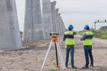 construction worker with helmet. Team surveyors  check  leveling of railway construction site.