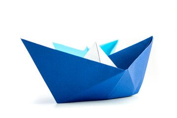 Paper colored boat isolated on white background with reflection. origami crafts. transport concept. origami