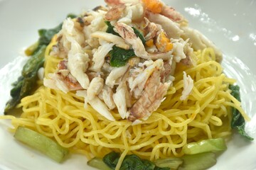 Chinese egg yellow noodles topping crab meat on plate