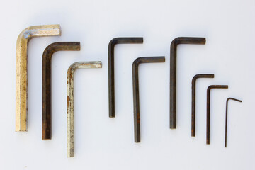 A collection of Allen wrenches, also known as hex keys. These tools are designed to drive bolts and screws with hexagonal sockets in their heads.