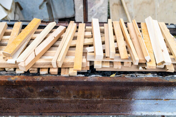 wooden sticks in large outdoor barbecue