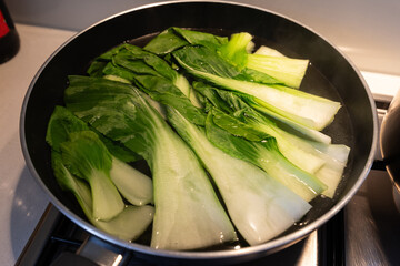 Bok choy blanching in the hot water.