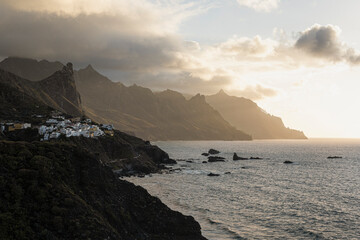 Tenerife, June 2022: A white village clinging to the cliffside as the sun sets