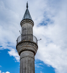 Fototapeta premium The high tower of the minaret against the sky.