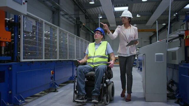 Female manager training a new employee with a disability for a job, explaining work on machines, full shot. Industry, inclusion and workplace concept.