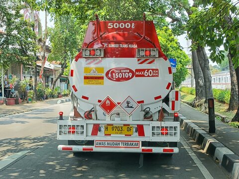 Jakarta, Indonesia - September 20, 2024: Rear view of a petrol cargo truck on the road. Fuel delivery transportation and logistic.