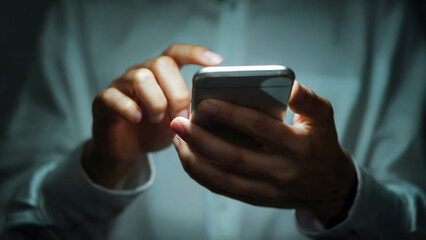 Close-up of Hands Typing on Smartphone in Low Light, Focus on Touchscreen Interaction and Fingertip Precision
