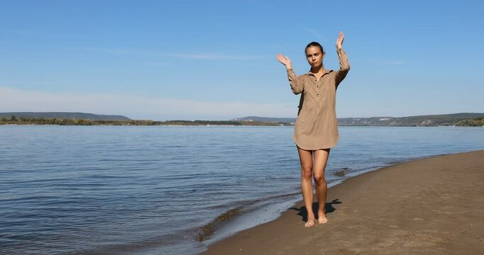 Photo posing - young beautiful girl shows correct poses for a photo on the beach