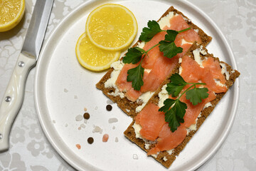 a crispbread sandwich with cream cheese and salmon slices top view
