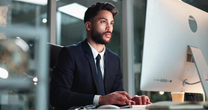 Computer, typing and man in office, night and serious for email, online and overtime for professional. Virtual assistant, web and writing of information in message, employee and confident with report