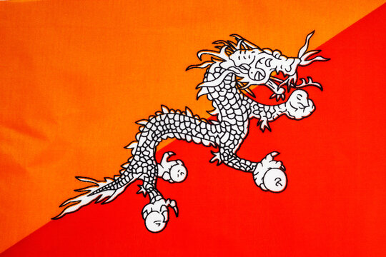 National flag of the state of Bhutan close-up. State background.